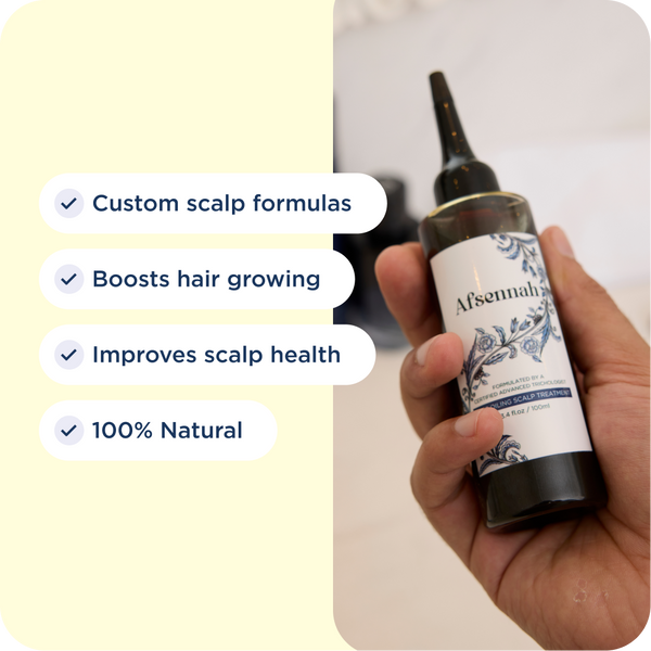 Hand holding the Afsennah Custom Hair Growth Oil for men with its key benefits listed
