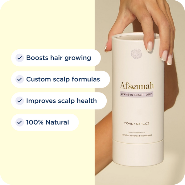 Hand holding the Afsennah Custom Scalp Tonic with its key benefits listed