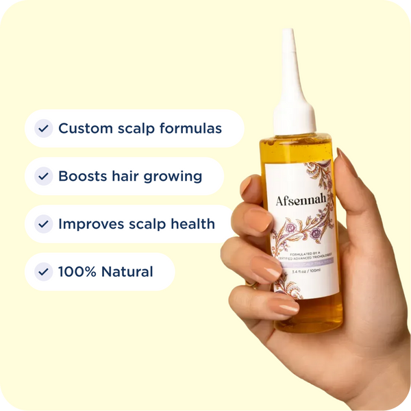 Hand holding the Afsennah Custom Hair Growth Treatment with its key benefits listed